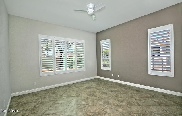 tiled empty room with ceiling fan