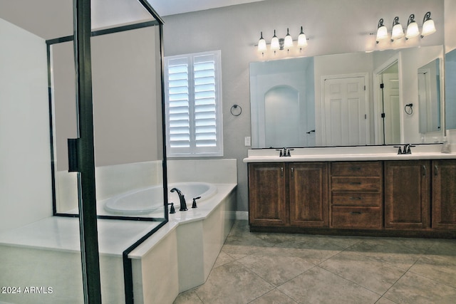 bathroom with a washtub, tile flooring, dual sinks, and large vanity