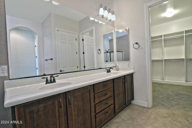 bathroom with double sink vanity and tile floors