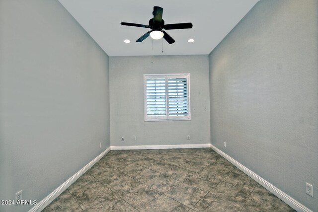 tiled empty room featuring ceiling fan