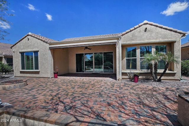 rear view of property featuring a patio and ceiling fan