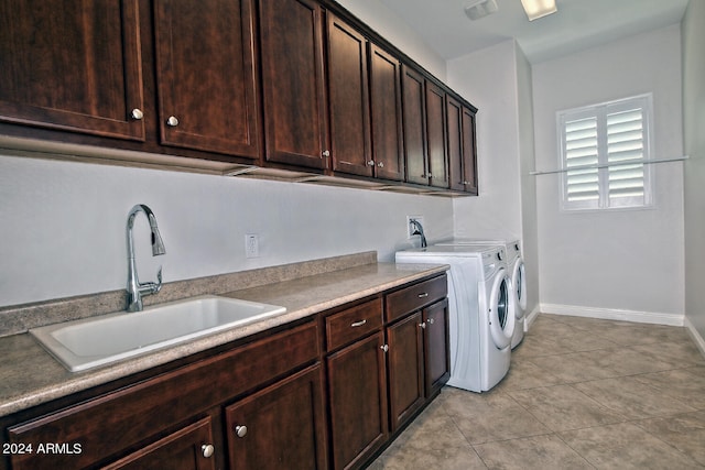 laundry room with washing machine and dryer, light tile flooring, cabinets, sink, and hookup for a washing machine