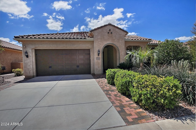 mediterranean / spanish-style house featuring a garage