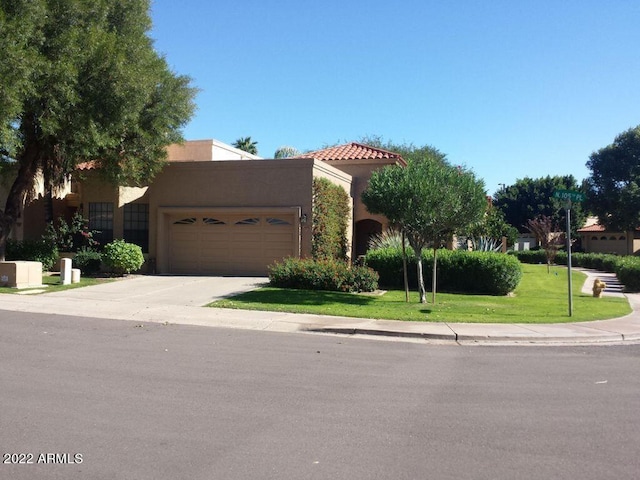 view of front of home featuring a garage and a front lawn