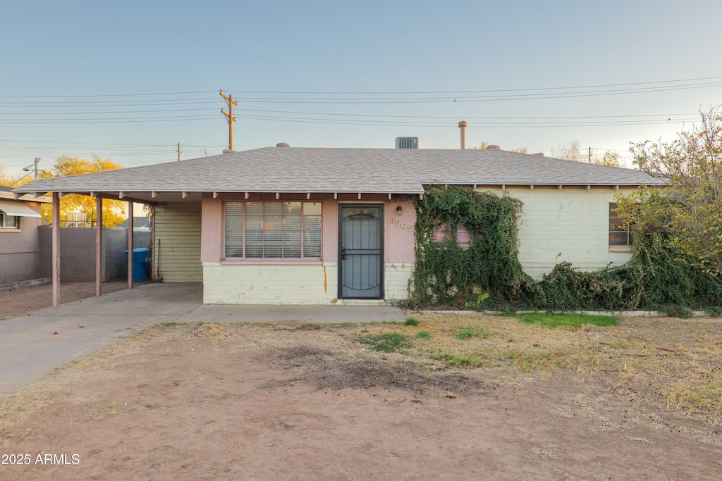 ranch-style home with a carport