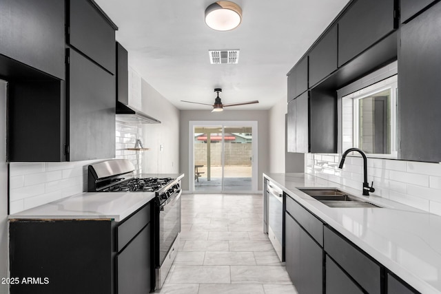 1010 W 5th Pl, Mesa, AZ 85201 - kitchen with stainless steel appliances, a sink, tasteful backsplash, light countertops, and dark cabinets