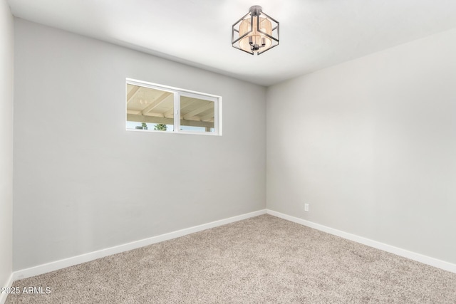 1010 W 5th Pl, Mesa, AZ 85201 - carpeted spare room featuring baseboards and a chandelier