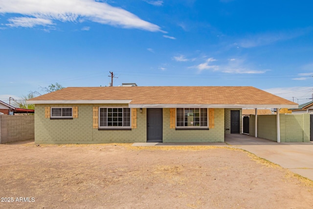 1010 W 5th Pl, Mesa, AZ 85201 - ranch-style home featuring an attached carport, driveway, brick siding, and a shingled roof
