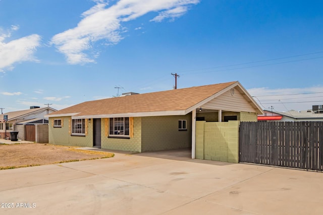 1010 W 5th Pl, Mesa, AZ 85201 - single story home with concrete driveway, brick siding, an attached carport, and roof with shingles