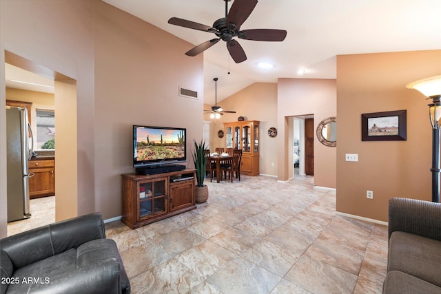 living room featuring ceiling fan and high vaulted ceiling