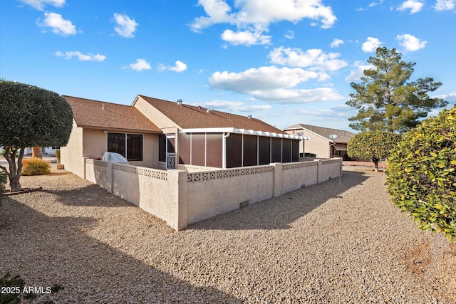 back of property featuring a sunroom