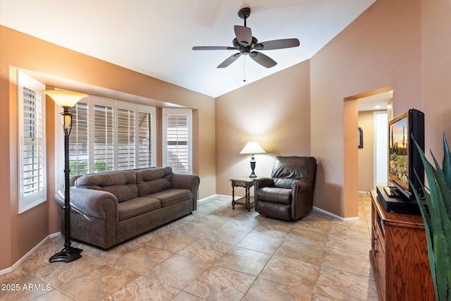 living room featuring ceiling fan and vaulted ceiling