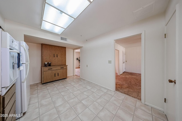 10326 W Pleasant Valley Rd, Sun City, AZ 85351 - kitchen with light carpet, light tile patterned floors, and visible vents