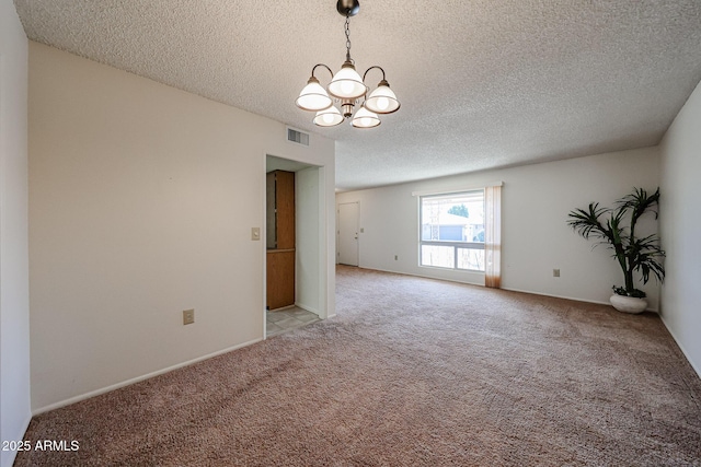 10326 W Pleasant Valley Rd, Sun City, AZ 85351 - unfurnished room featuring light carpet, visible vents, a chandelier, and a textured ceiling