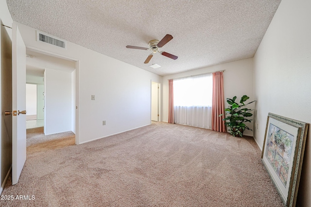 10326 W Pleasant Valley Rd, Sun City, AZ 85351 - spare room with light carpet, ceiling fan, visible vents, and a textured ceiling