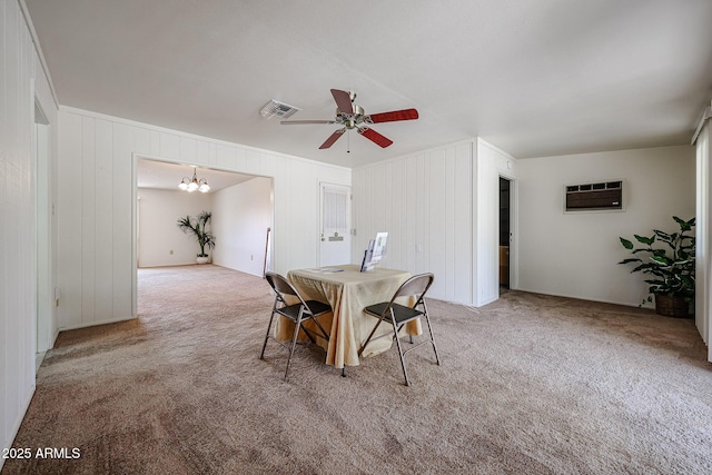 10326 W Pleasant Valley Rd, Sun City, AZ 85351 - dining area with a wall unit AC, light carpet, visible vents, and ceiling fan with notable chandelier