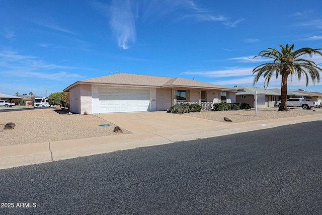 10326 W Pleasant Valley Rd, Sun City, AZ 85351 - single story home with a garage, brick siding, driveway, and a shingled roof