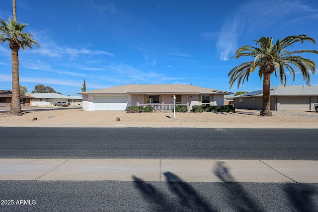 10326 W Pleasant Valley Rd, Sun City, AZ 85351 - ranch-style house featuring covered porch, driveway, and an attached garage