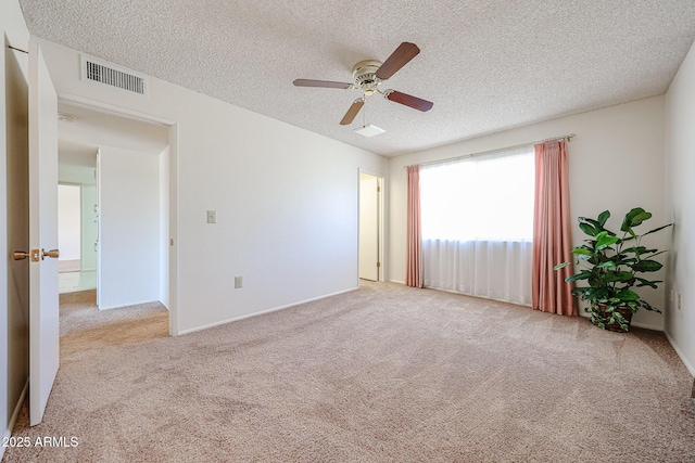 10326 W Pleasant Valley Rd, Sun City, AZ 85351 - spare room featuring visible vents, light carpet, and a textured ceiling