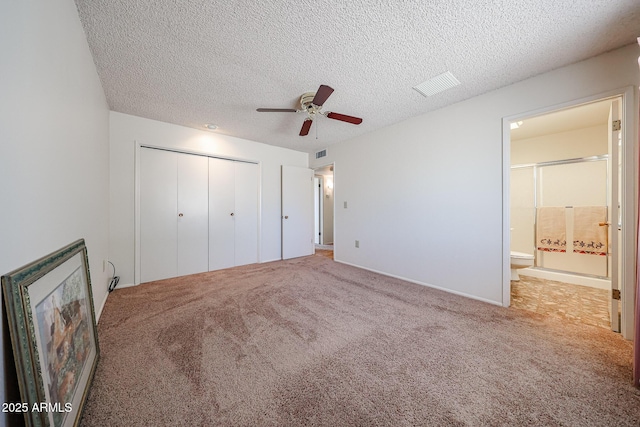 10326 W Pleasant Valley Rd, Sun City, AZ 85351 - unfurnished bedroom featuring visible vents, connected bathroom, a textured ceiling, carpet floors, and a closet