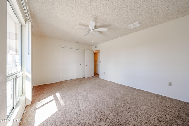10326 W Pleasant Valley Rd, Sun City, AZ 85351 - unfurnished bedroom with carpet, a closet, visible vents, and a textured ceiling