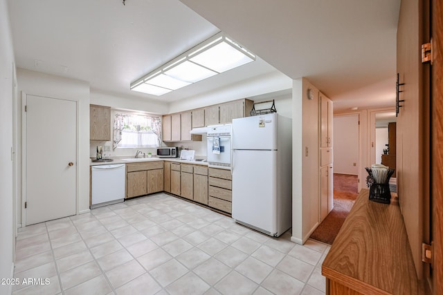 10326 W Pleasant Valley Rd, Sun City, AZ 85351 - kitchen featuring white appliances, light countertops, a sink, and under cabinet range hood
