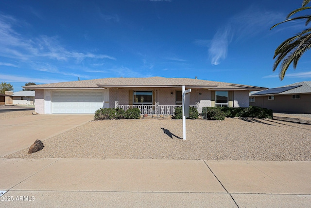 10326 W Pleasant Valley Rd, Sun City, AZ 85351 - ranch-style home featuring a garage, driveway, a porch, and brick siding