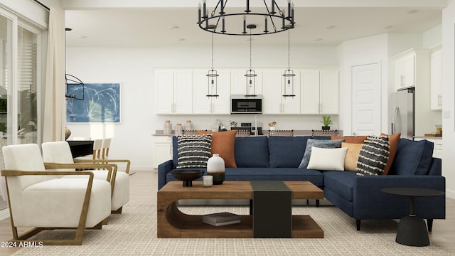 living room with a notable chandelier and light hardwood / wood-style flooring