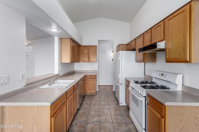 kitchen with stainless steel dishwasher, vaulted ceiling, dark tile patterned floors, white range with gas cooktop, and sink