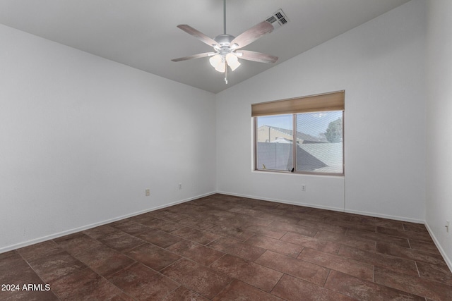 empty room with ceiling fan and vaulted ceiling