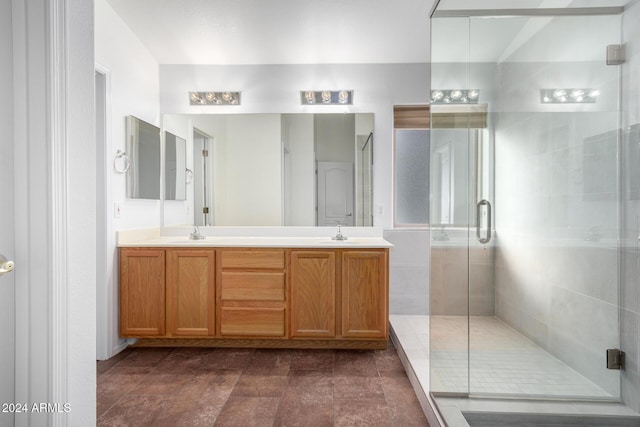 bathroom with vanity and a shower with shower door