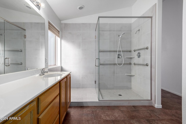 bathroom with vanity, an enclosed shower, and lofted ceiling