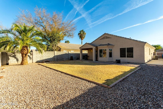 back of property featuring central AC