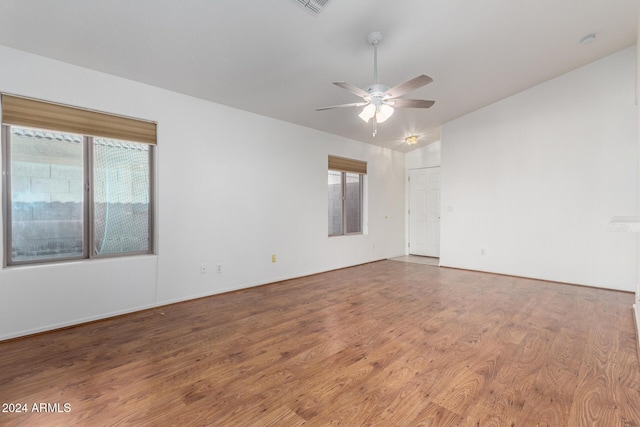 empty room featuring ceiling fan, hardwood / wood-style floors, and lofted ceiling