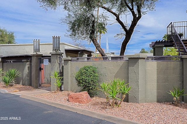 exterior space featuring a fenced front yard and a gate