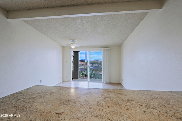 empty room featuring light speckled floor and a textured ceiling