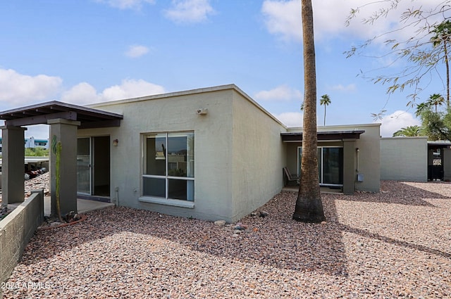 back of house with stucco siding