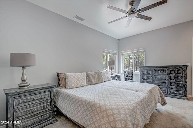 carpeted bedroom featuring vaulted ceiling and ceiling fan