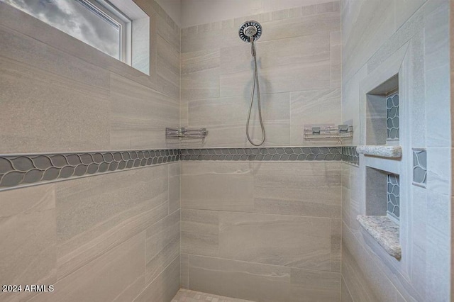 bathroom featuring tiled shower