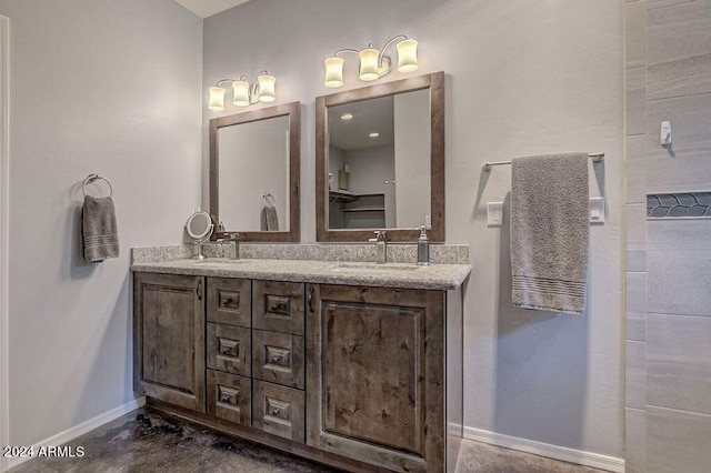 bathroom with vanity and concrete flooring