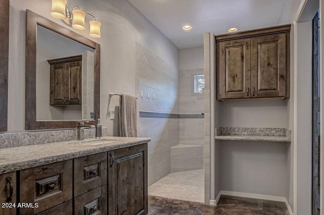 bathroom with vanity and tiled shower