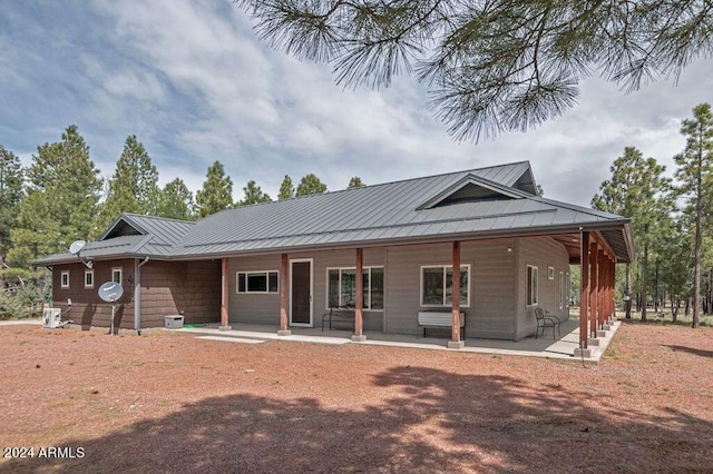 back of house featuring a porch