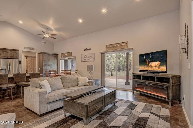 living room featuring a barn door, high vaulted ceiling, and ceiling fan