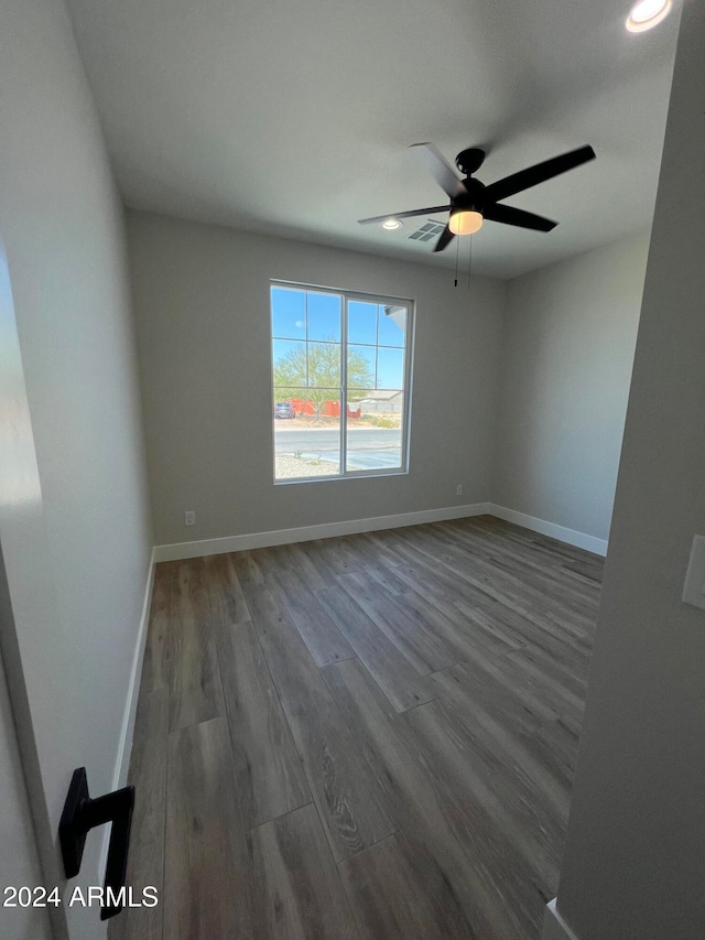 unfurnished room with hardwood / wood-style floors and ceiling fan