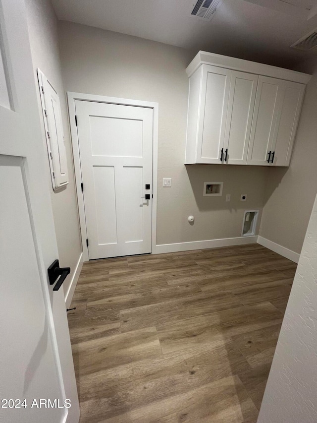 laundry area featuring washer hookup, hookup for an electric dryer, hardwood / wood-style floors, cabinets, and electric panel