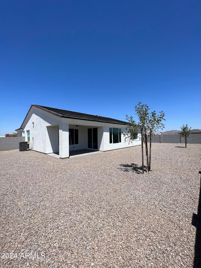 rear view of house featuring cooling unit