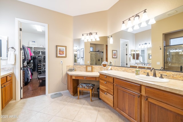 bathroom with vanity, tile patterned flooring, and a shower with door