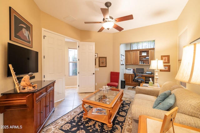 living room featuring light tile patterned floors and ceiling fan