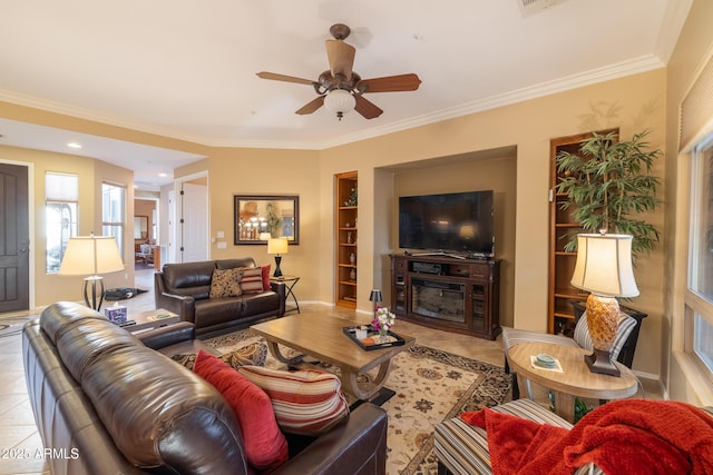 tiled living room featuring built in shelves, ceiling fan, and crown molding