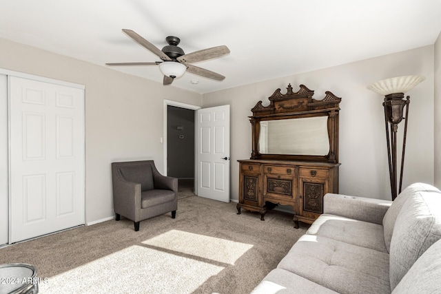 carpeted living room featuring ceiling fan